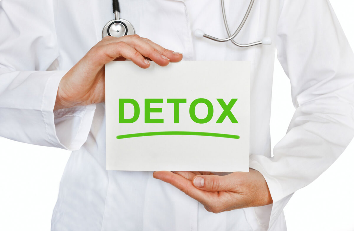 doctor holding card with detox text