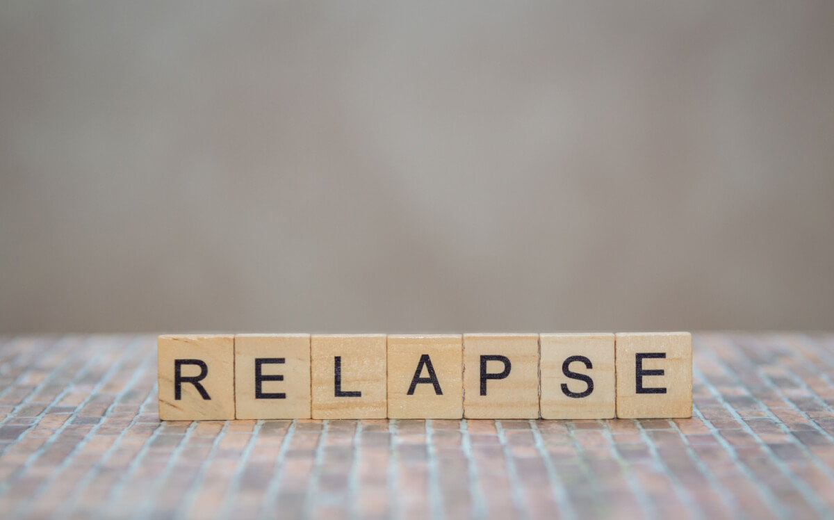 word relapse made of wooden cubes
