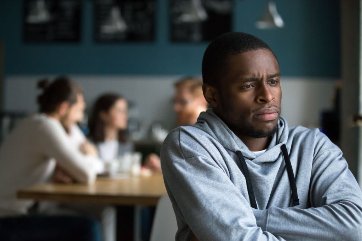 black male isolating himself from friends