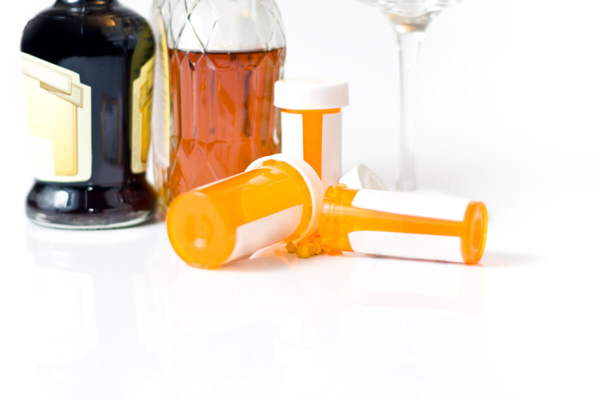 pill bottles with alcohol bottles