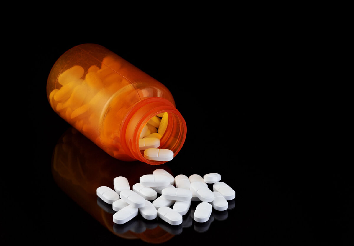 prescription bottle with pills coming out