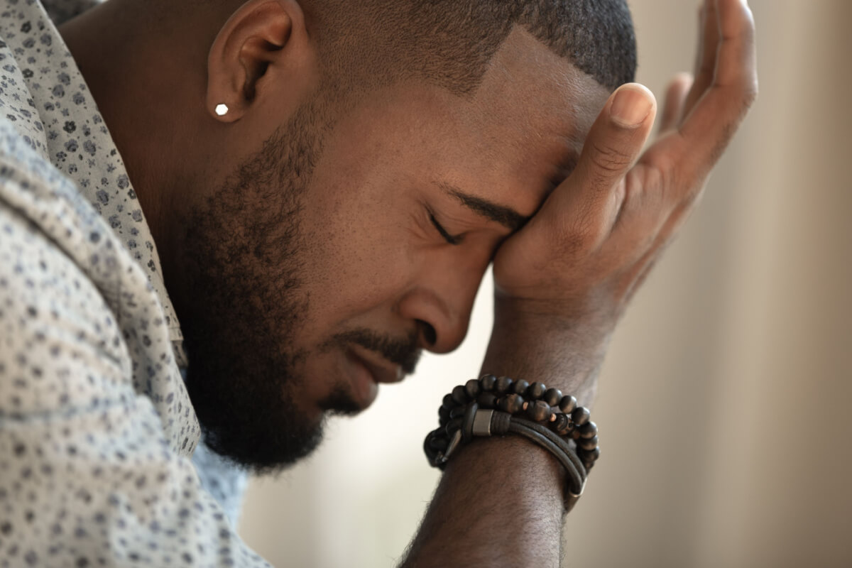 stressed young black man coping with anxiety