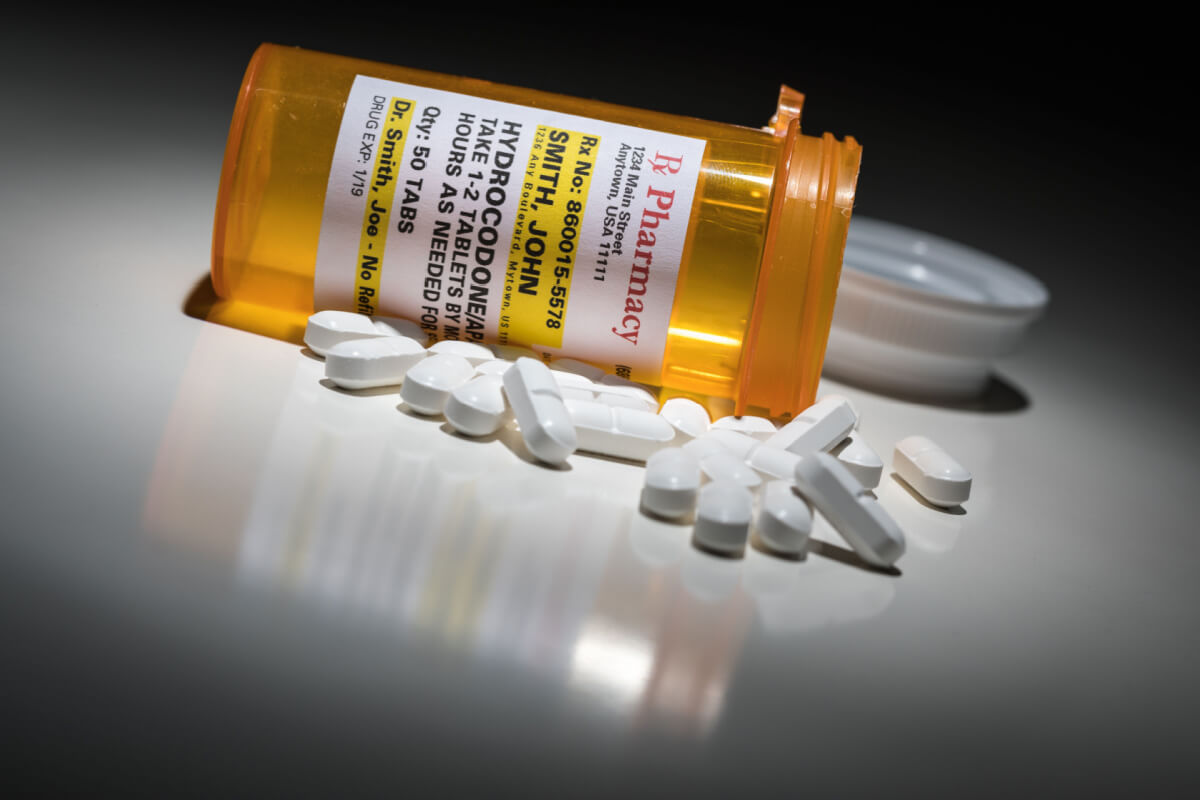 Hydrocodone pills with prescription bottle