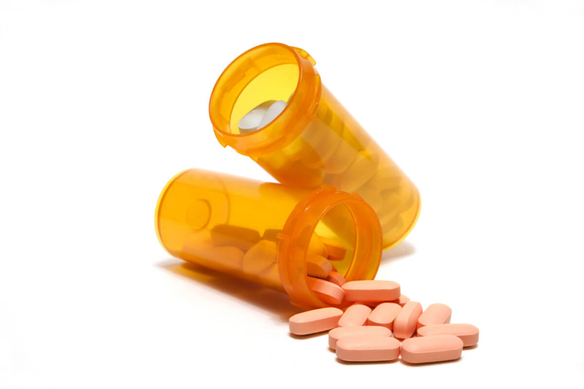 Two prescription pill bottles with pills