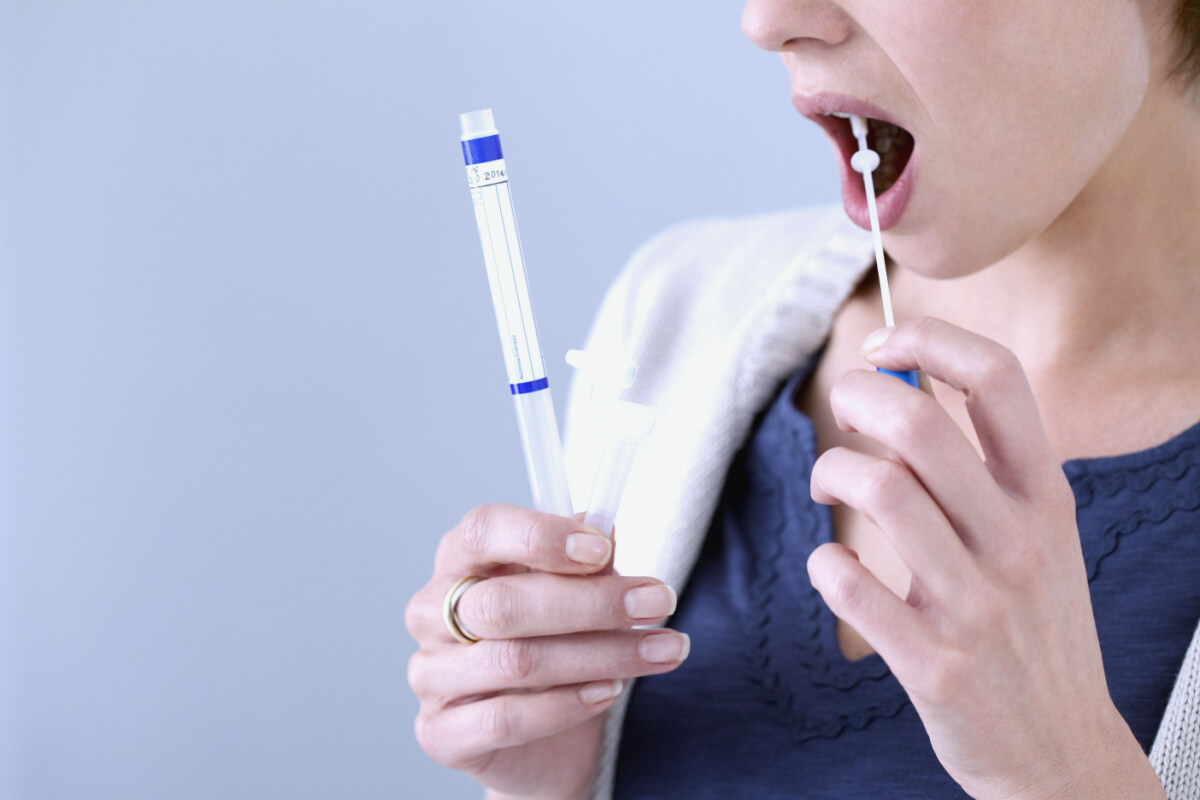 Woman taking saliva drug test