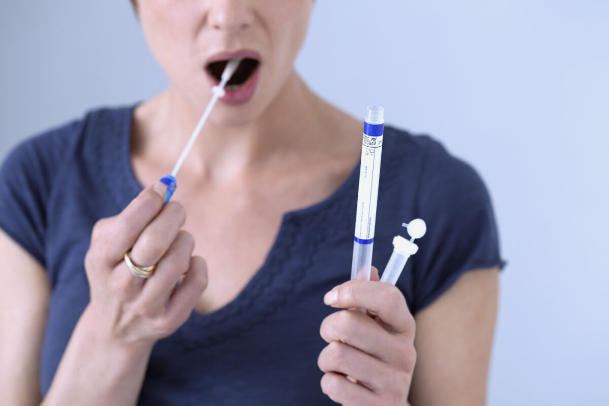Young woman taking saliva drug test